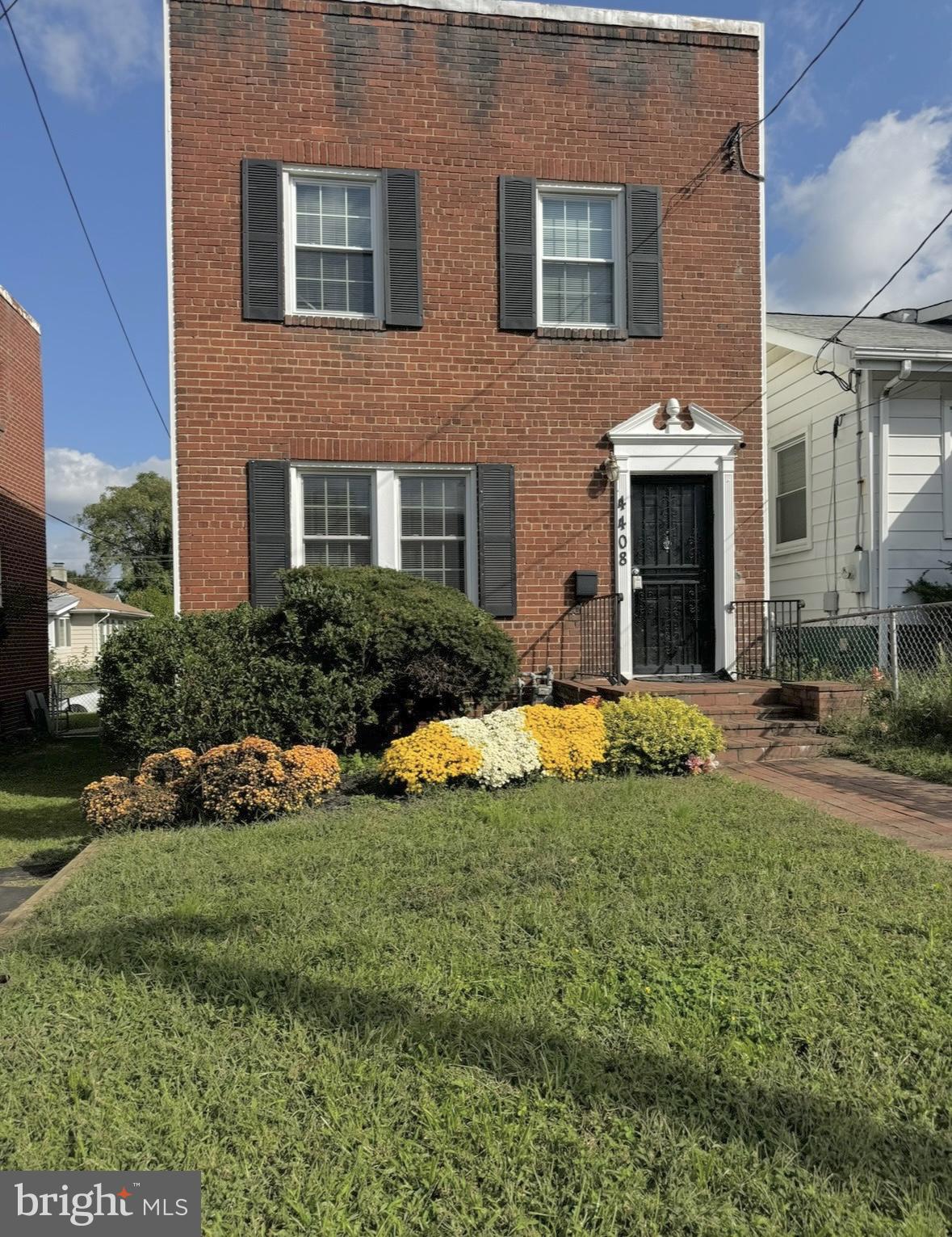 a view of a house with a yard and plants