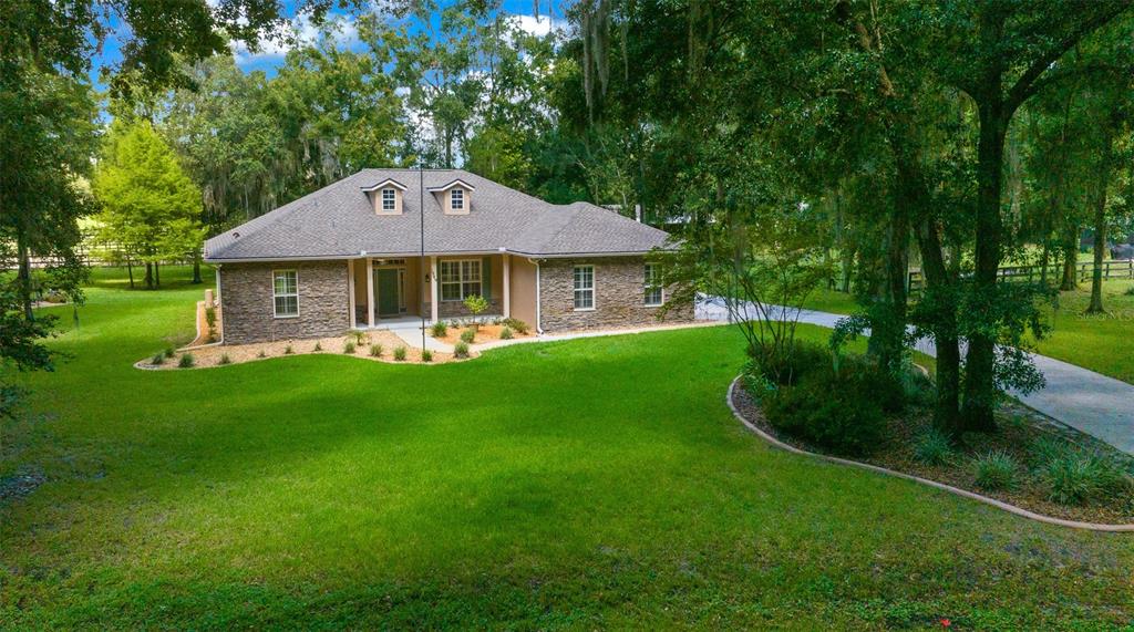 a front view of a house with garden