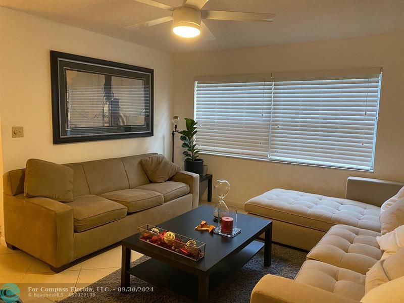 a living room with furniture and a window