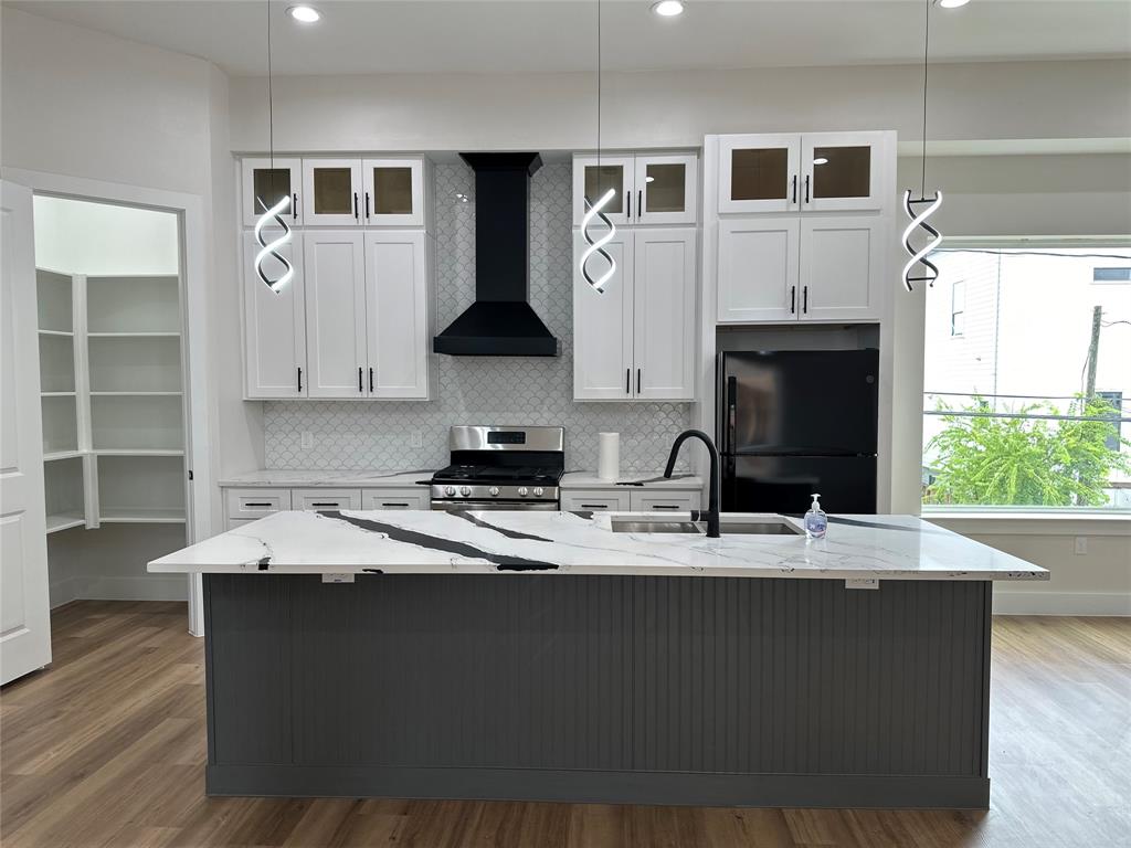 a kitchen with stainless steel appliances granite countertop a sink a stove and a microwave