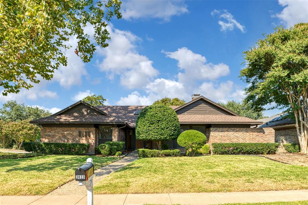 a view of a house with a big yard and large tree