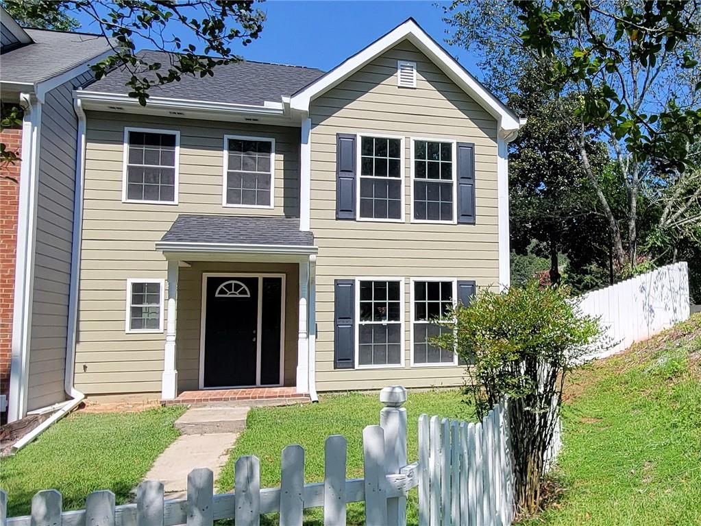 a front view of a house with a garden