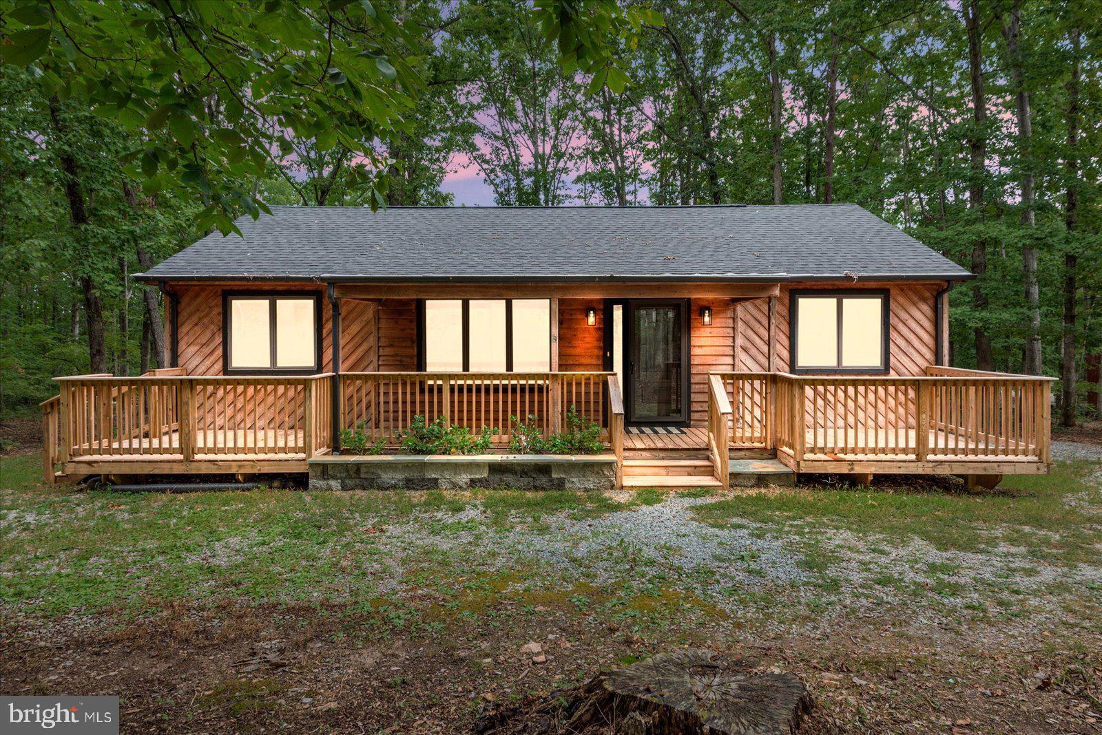 a view of a house with yard and sitting area