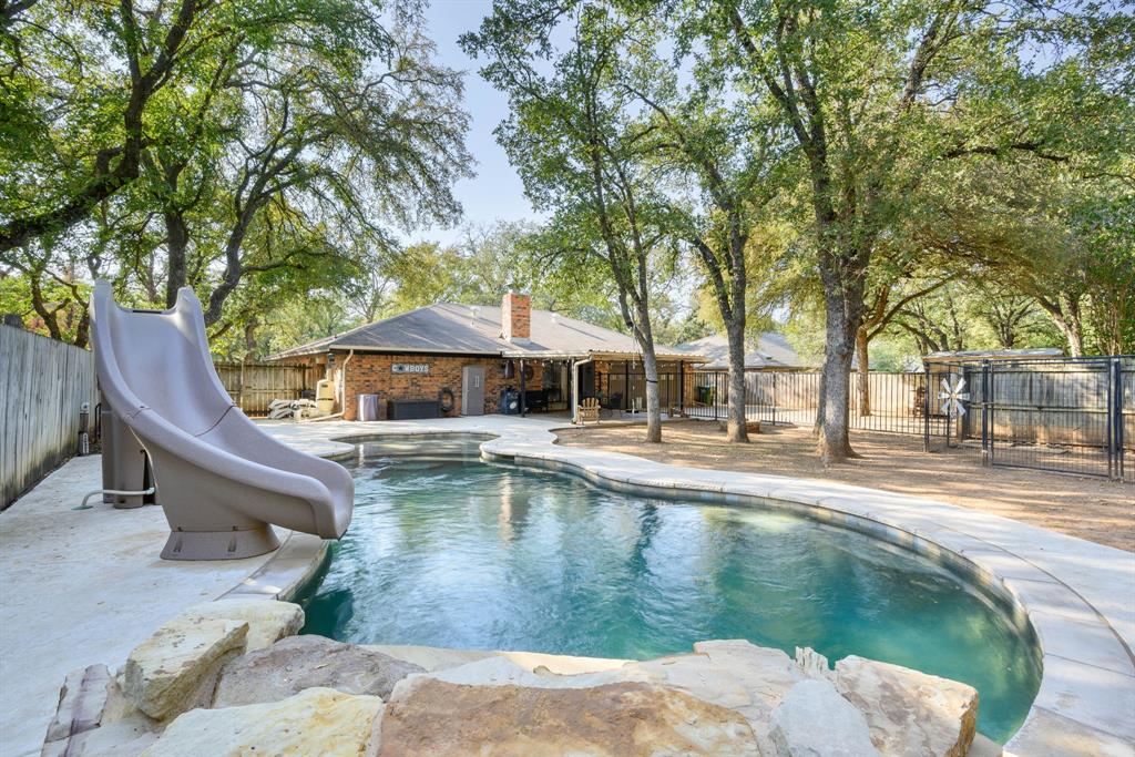 a swimming pool with outdoor seating and yard