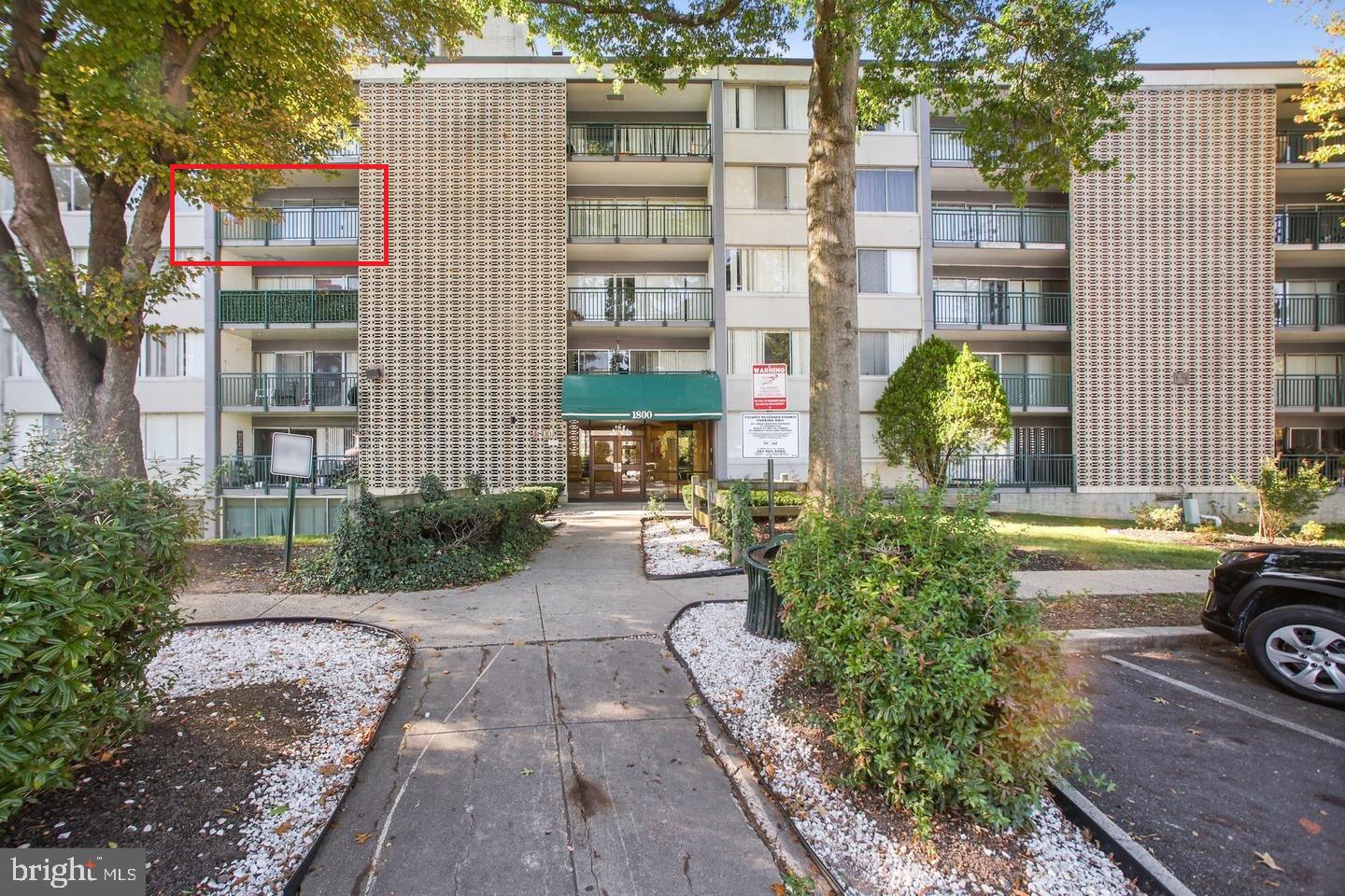 a view of a building with a yard and sitting area