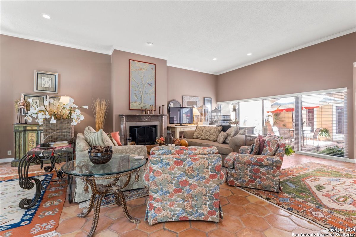 a living room with fireplace furniture and a fireplace