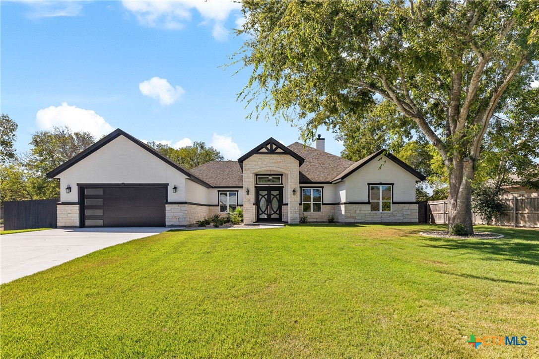 a house view with a sitting space and garden