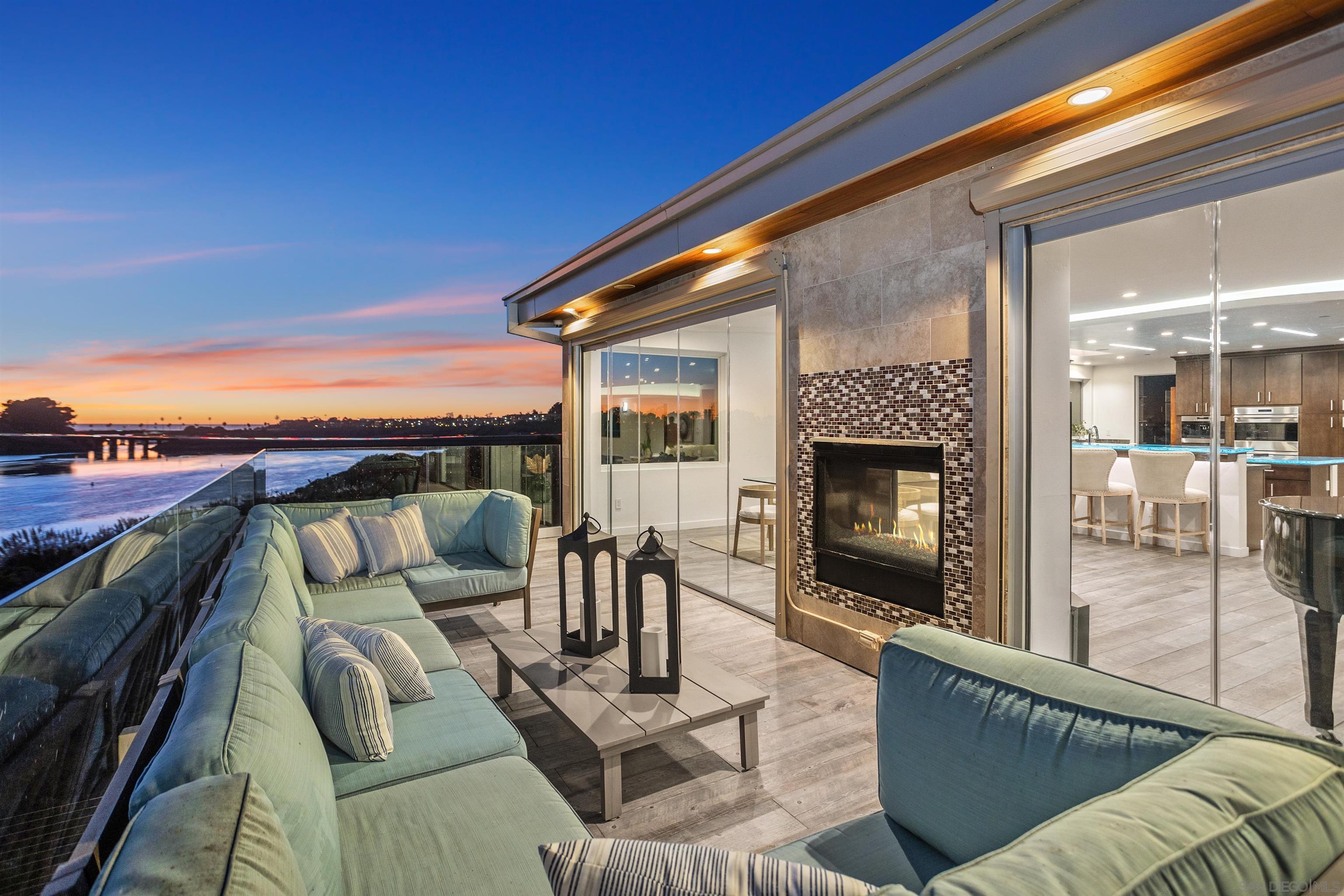 a balcony with furniture and a fireplace