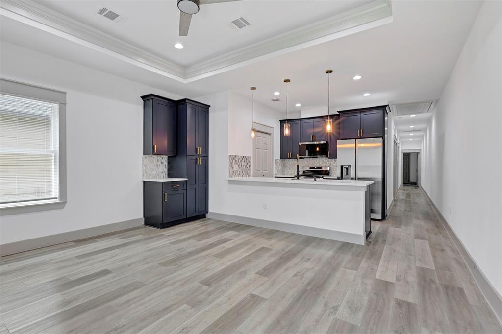 a view of kitchen with refrigerator microwave and cabinets