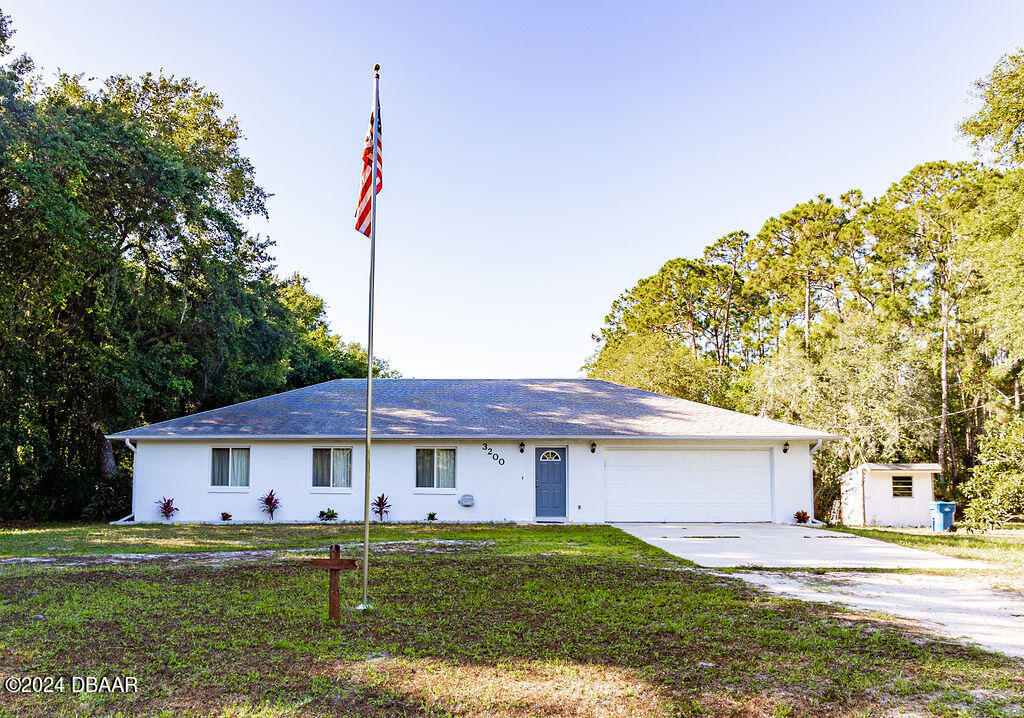 a view of a yard in front of a house with large trees