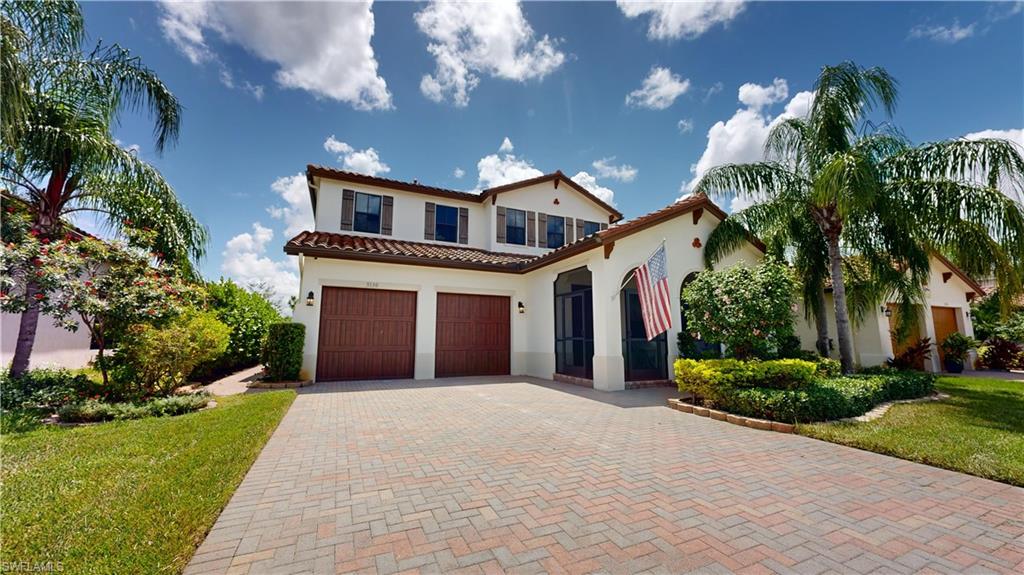 a front view of a house with a yard and garage