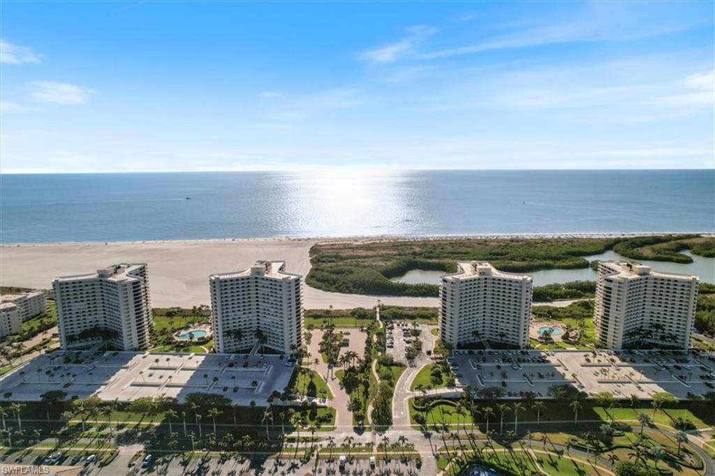 Drone / aerial view with a view of the beach and a water view