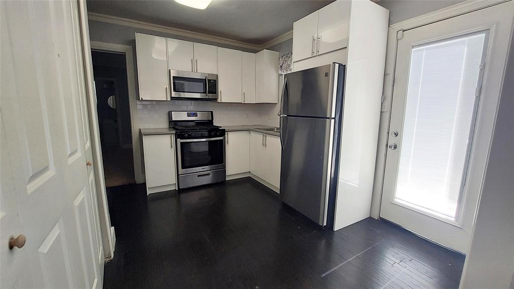 Spacious kitchen with door leading to the back yard.