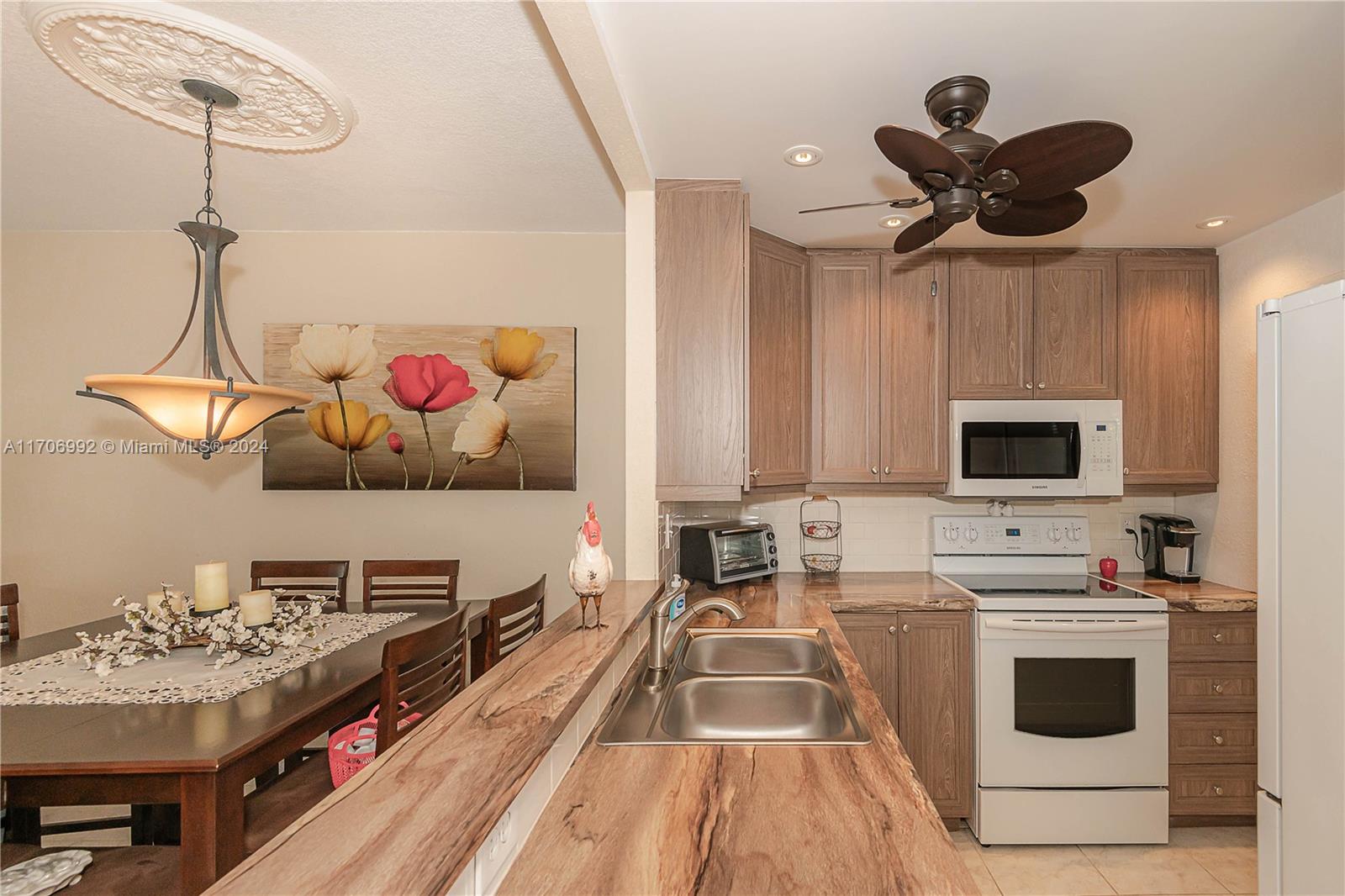 a kitchen with stainless steel appliances a stove a sink and a refrigerator