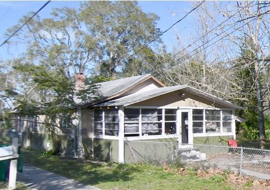 a front view of a house with a yard table and chairs