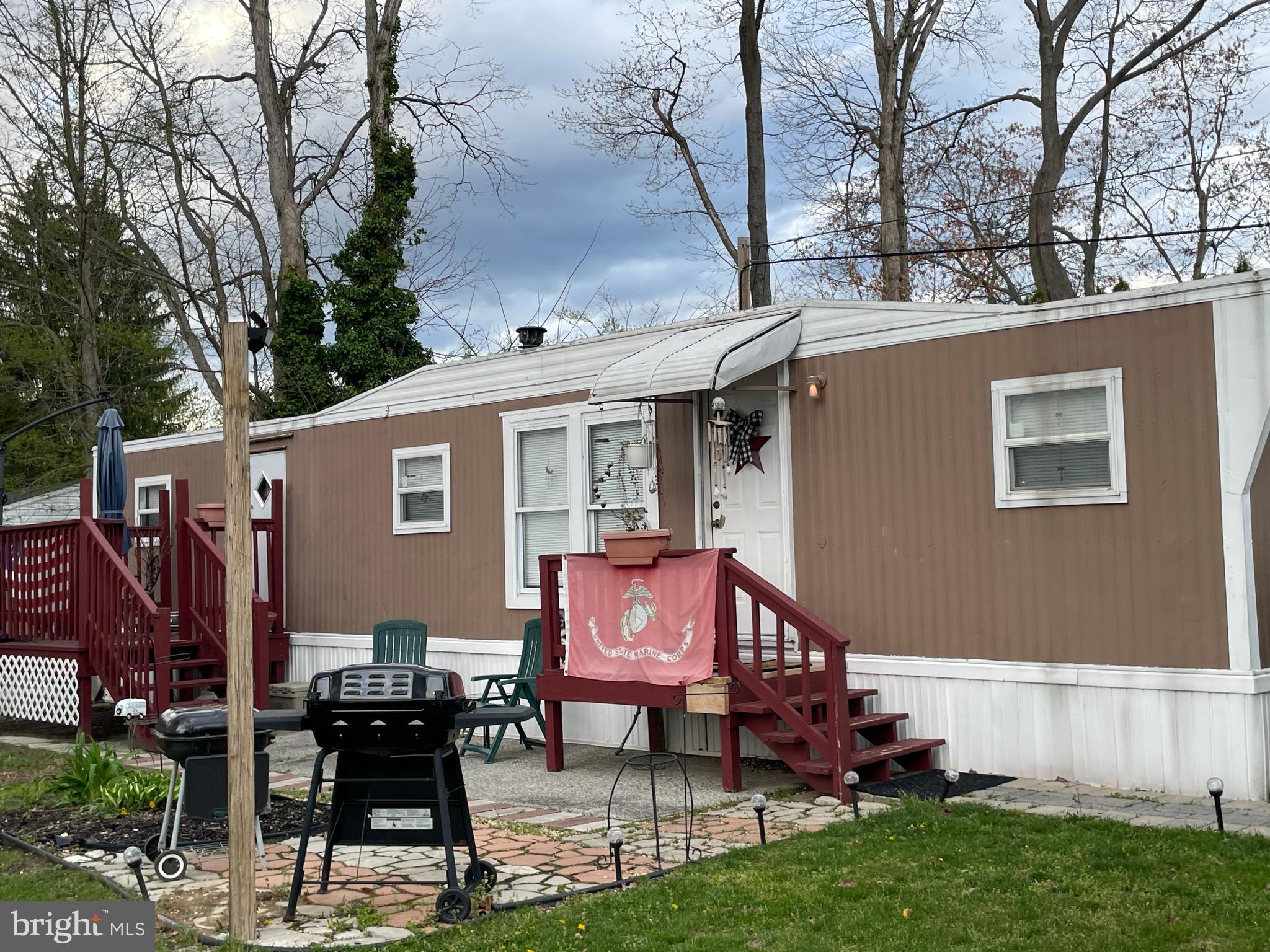 a view of a chairs and table in the back yard of the house