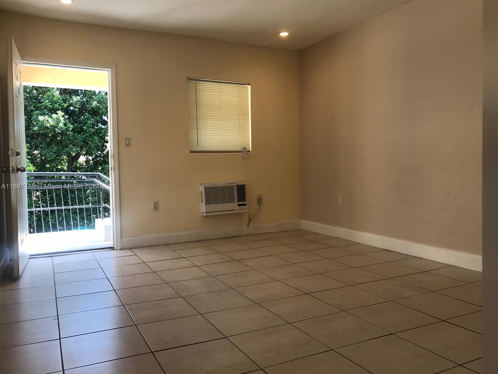 a view of an empty room and a window