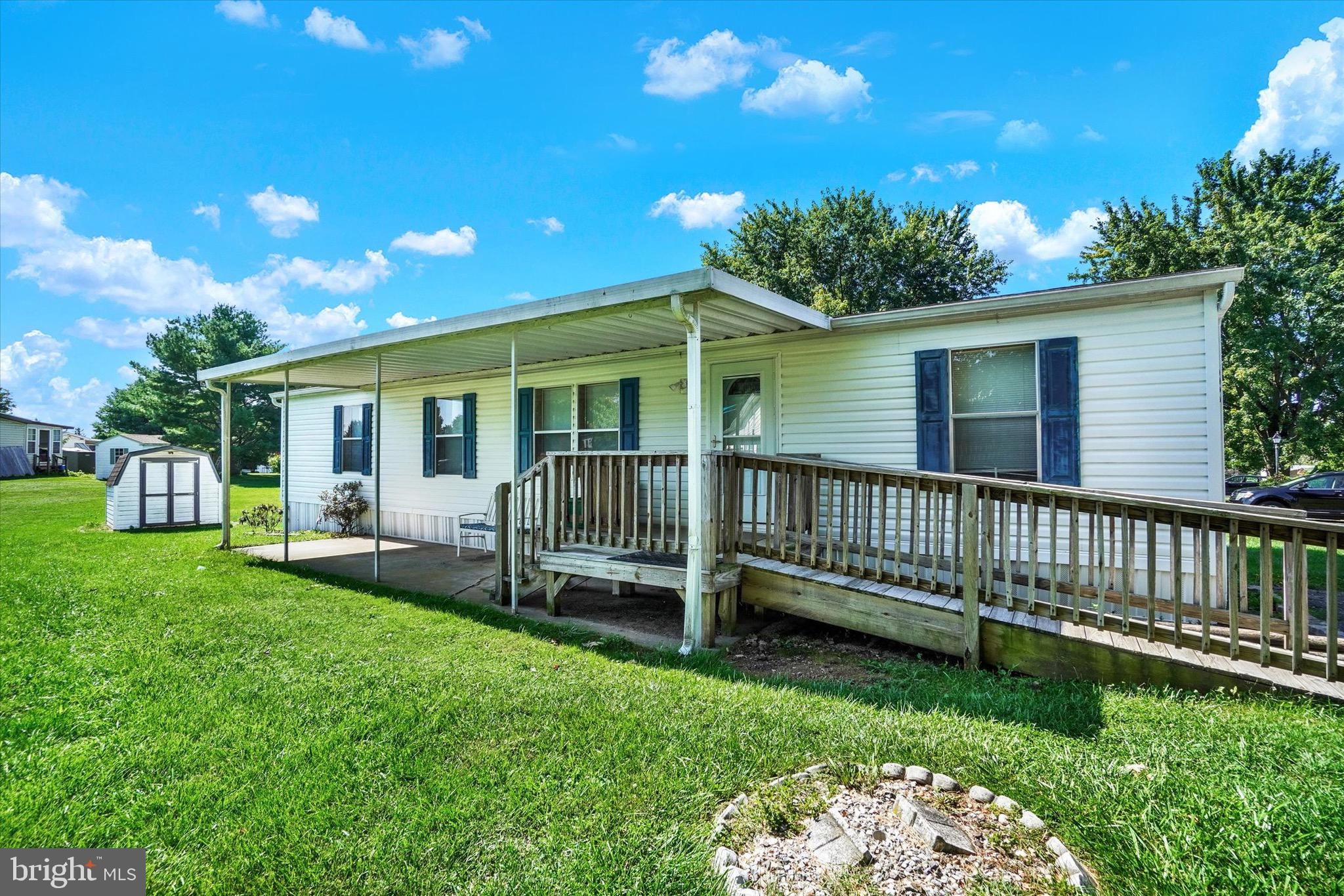 a view of a house with a backyard and porch