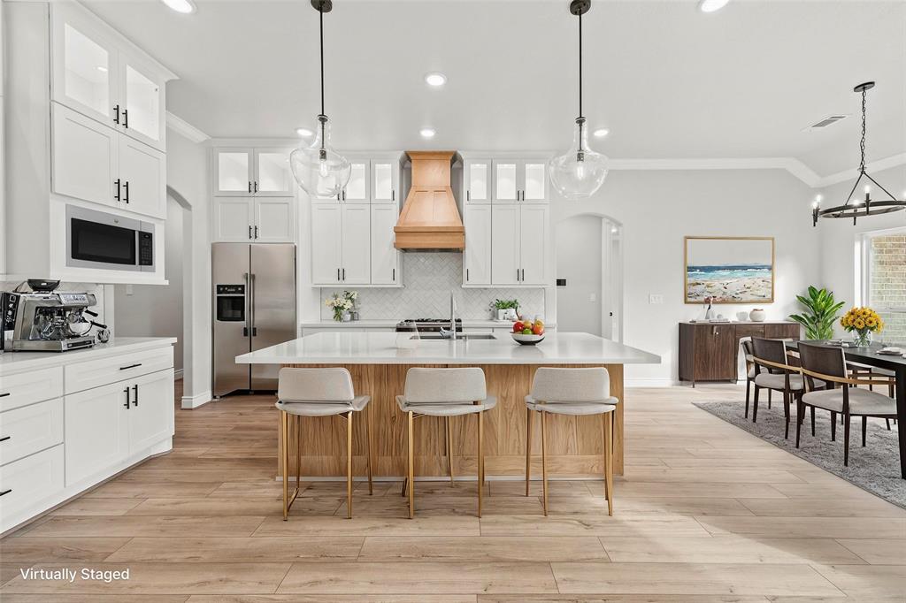 a large kitchen with a table and chairs in it