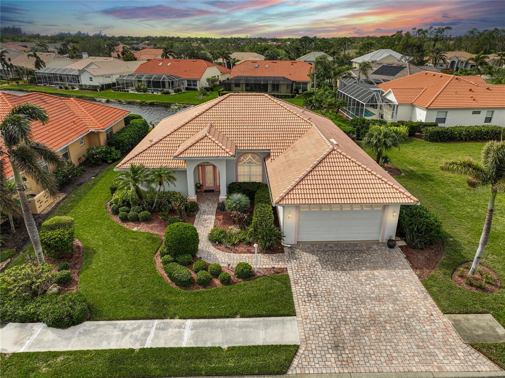 an aerial view of a house with a yard and lake view