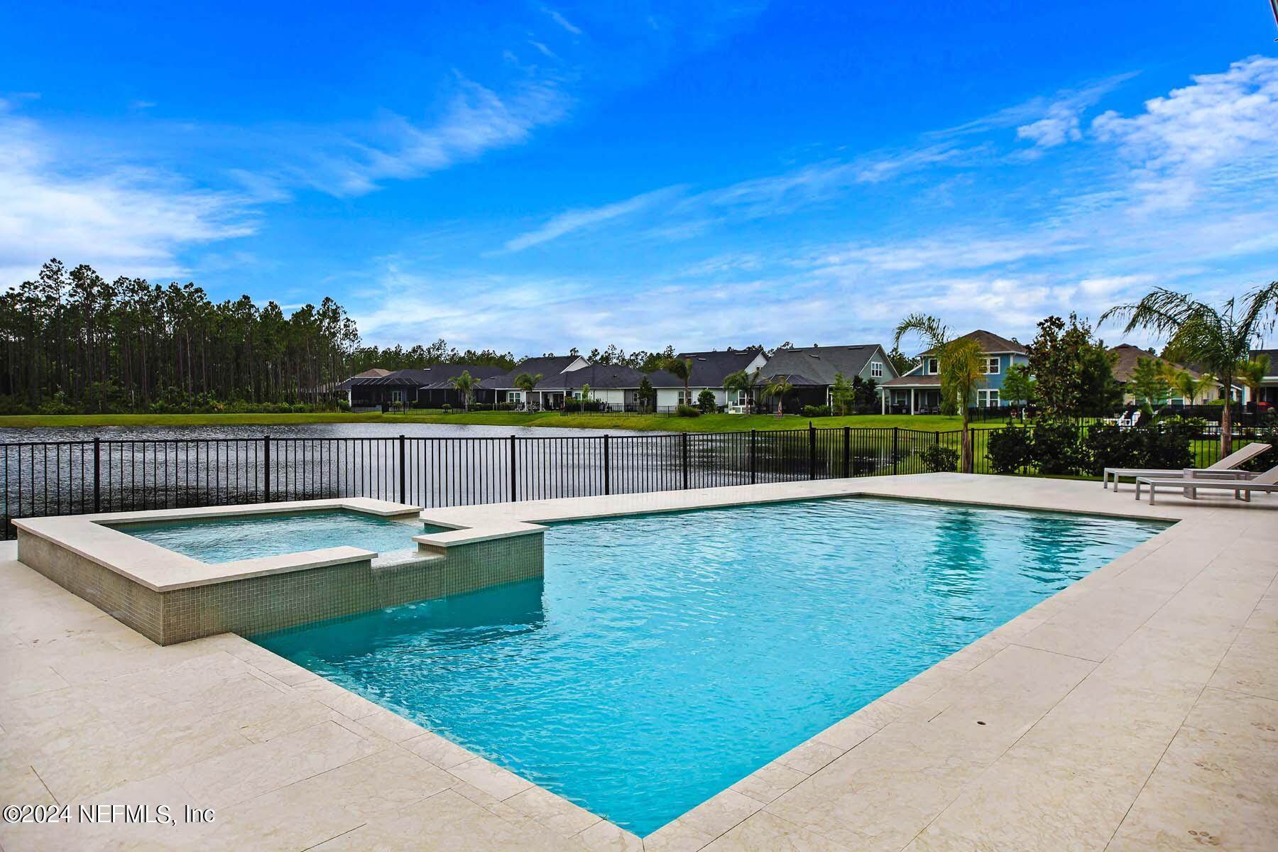 Custom pool with marble tile pool deck