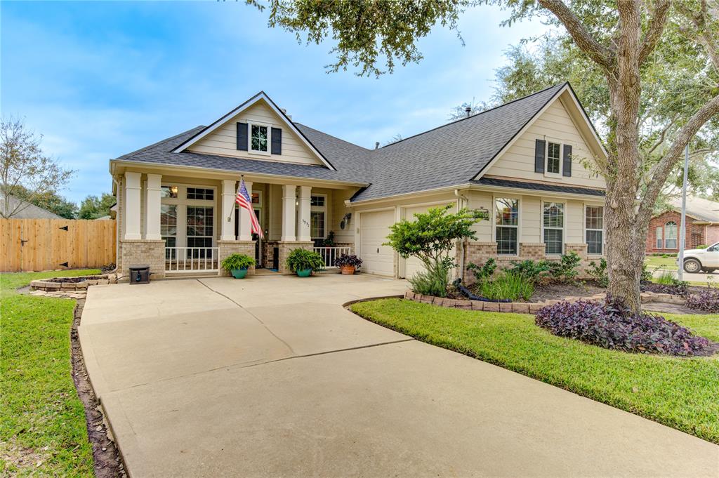 a front view of a house with a yard and potted plants