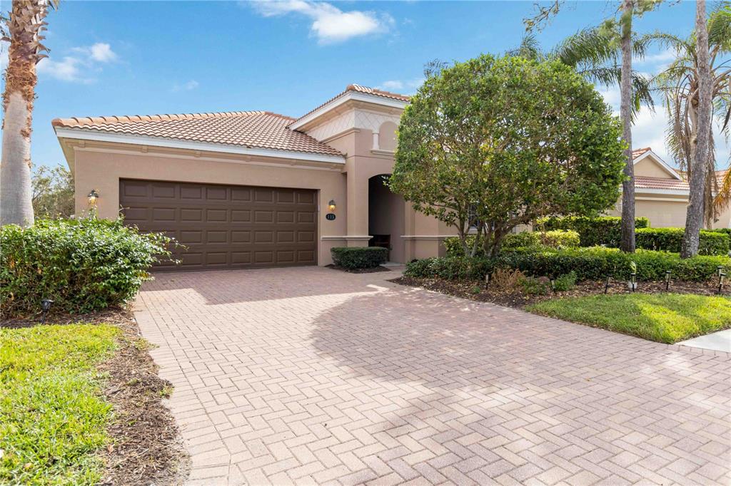 a front view of a house with a yard and garage