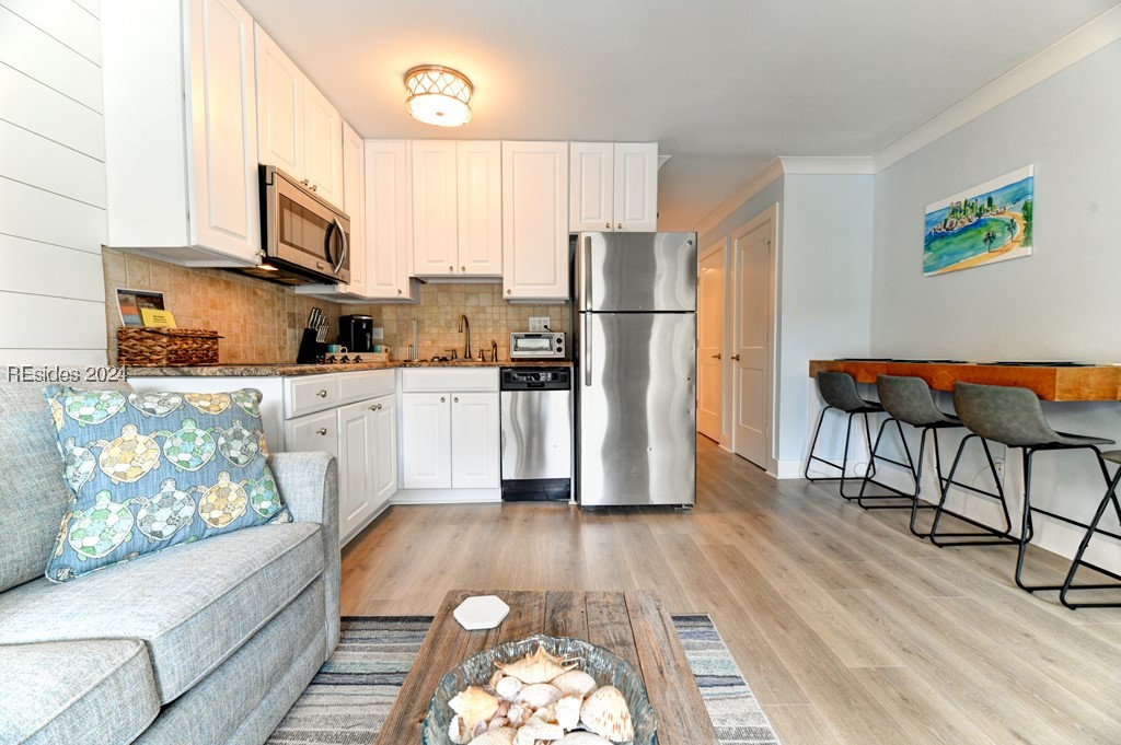 Kitchen with tasteful backsplash, appliances with