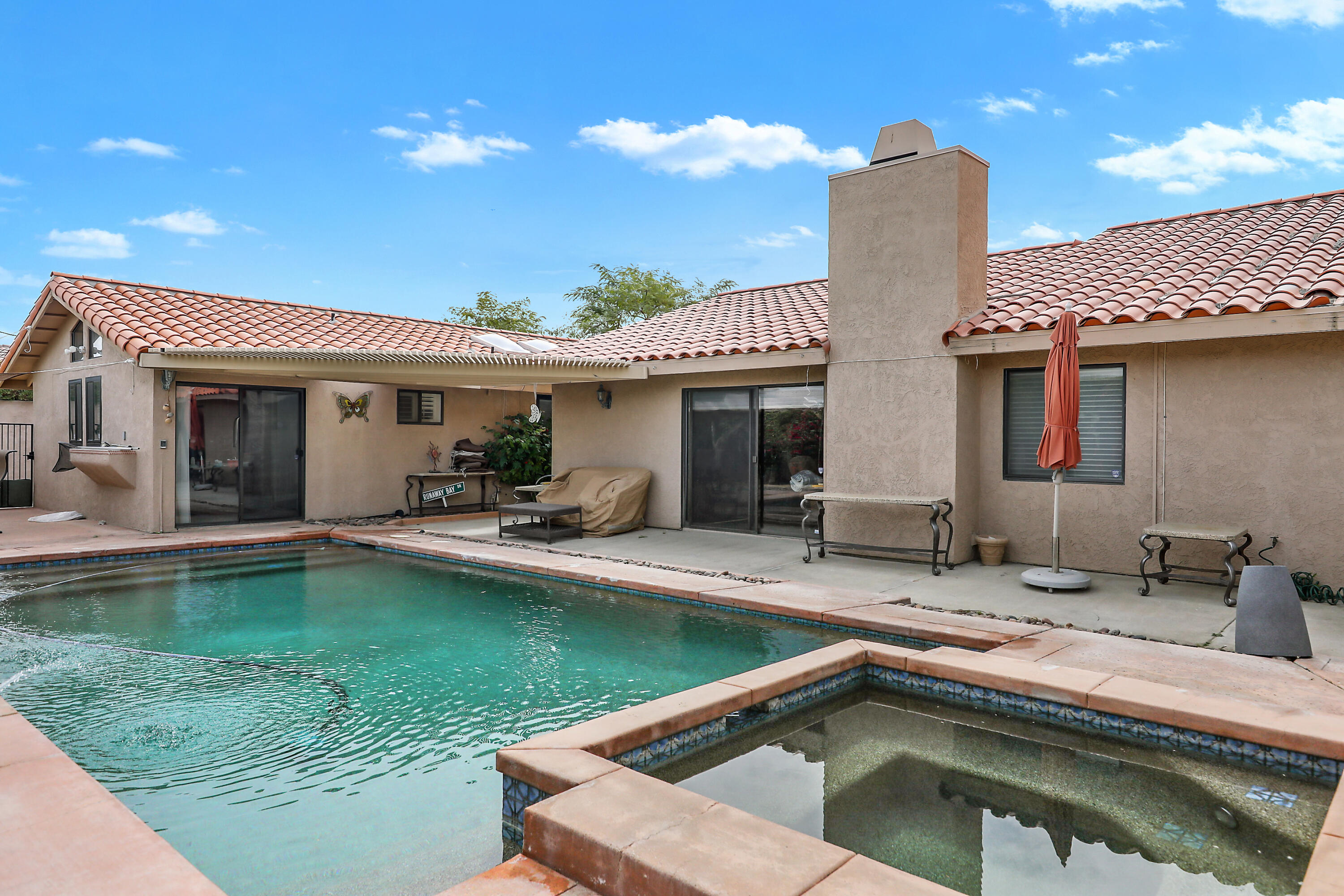 a view of a house with swimming pool and a yard