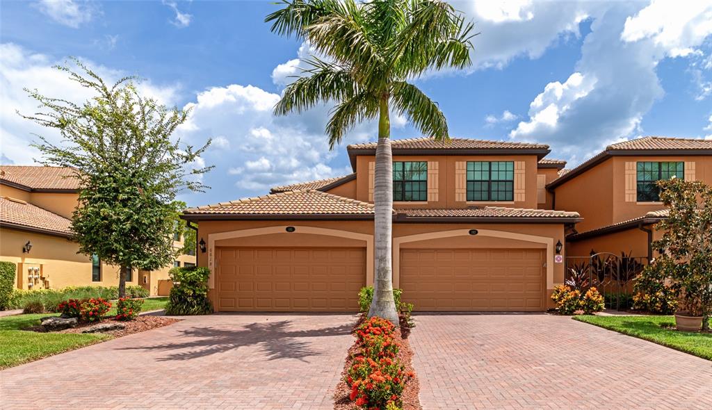 a front view of a house with a yard and garage