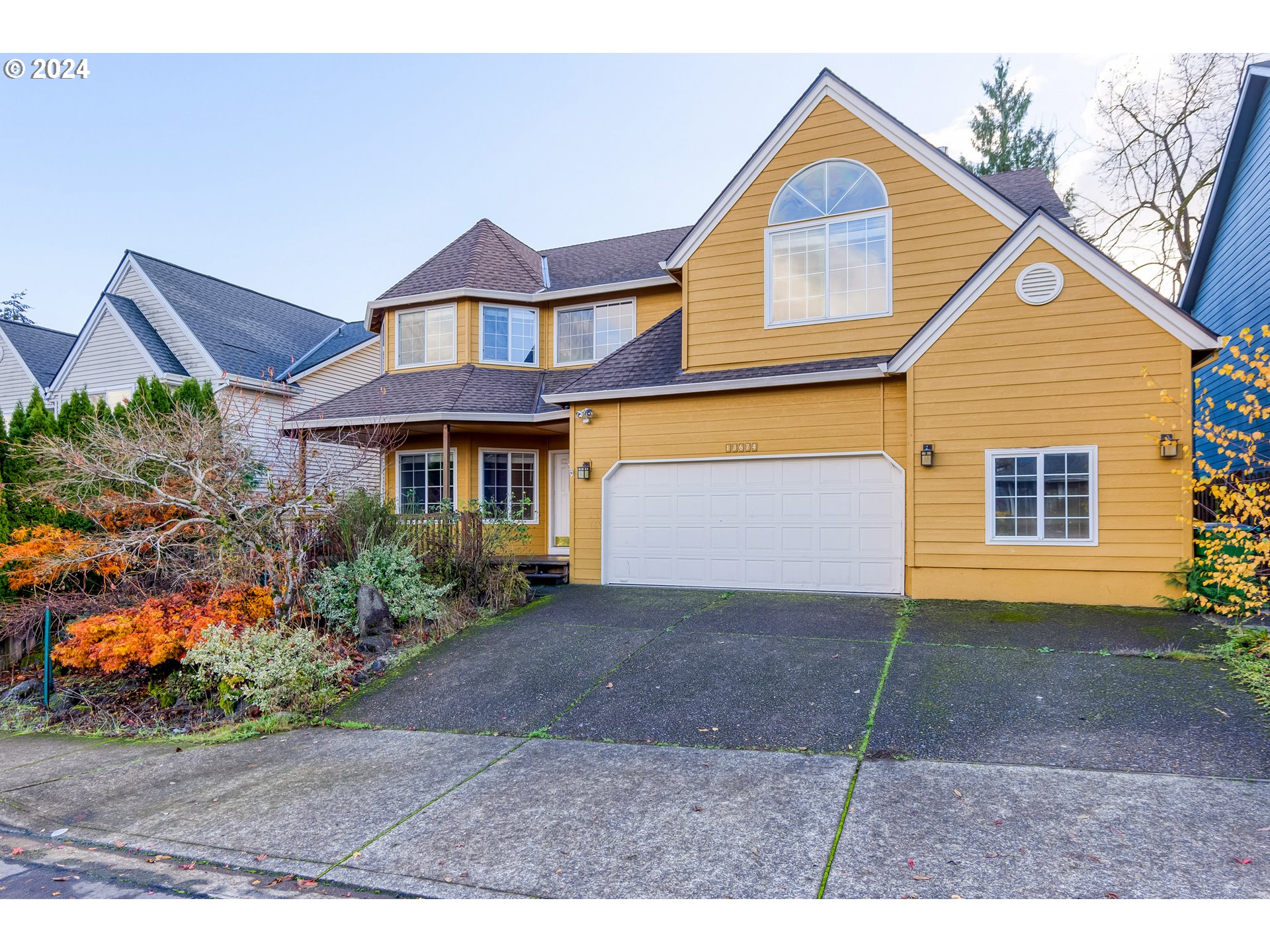 a front view of a house with a yard and garage