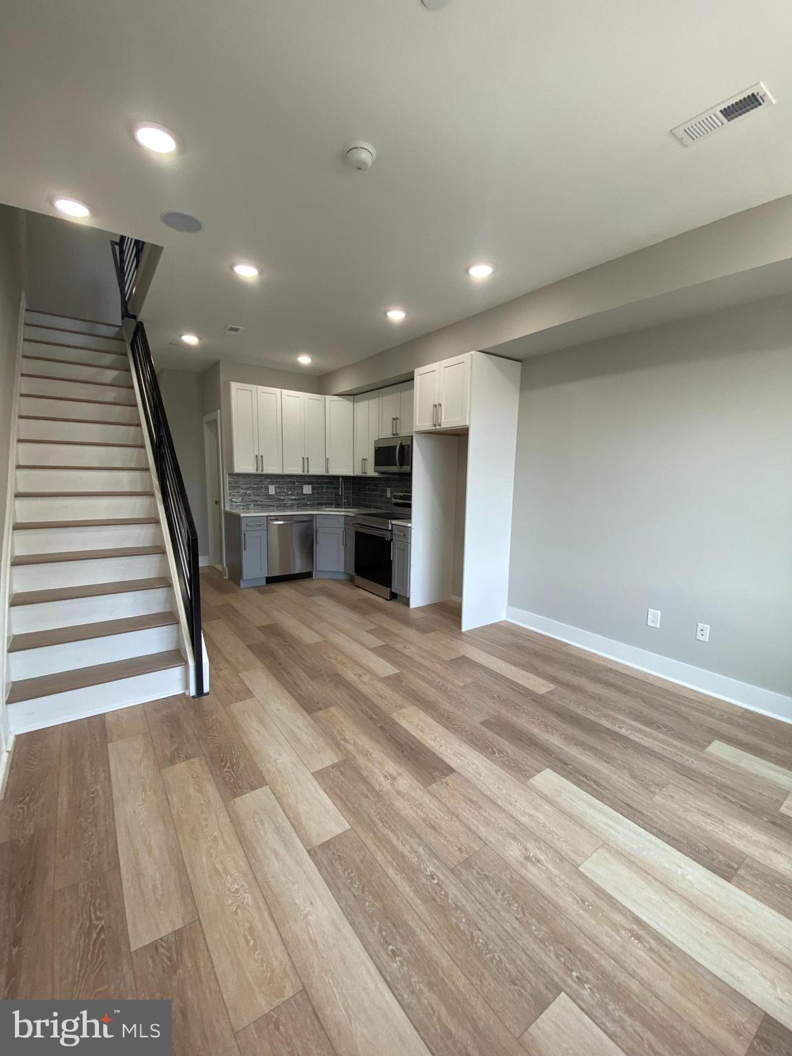 a view of a hallway with stairs and a window