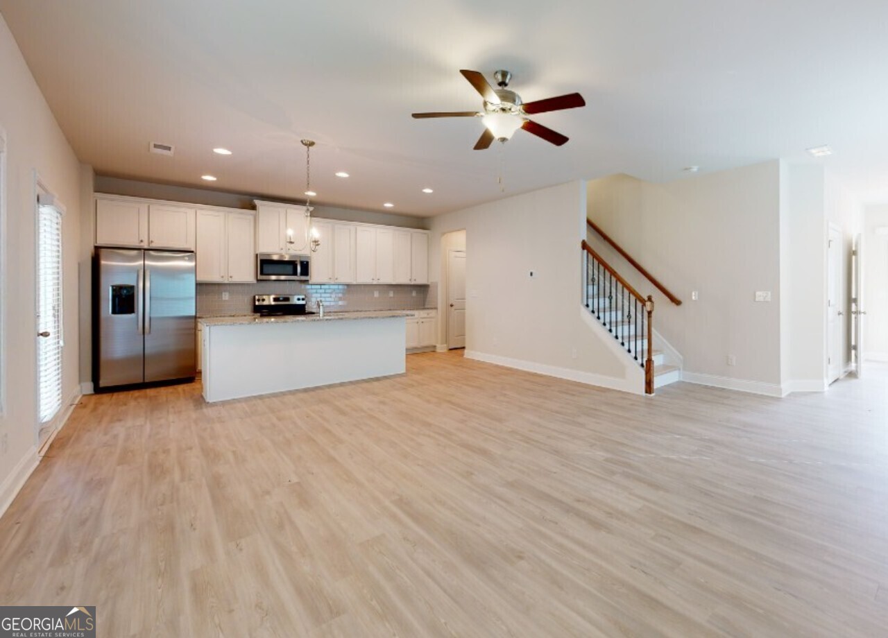 a view of a kitchen with a sink and a refrigerator