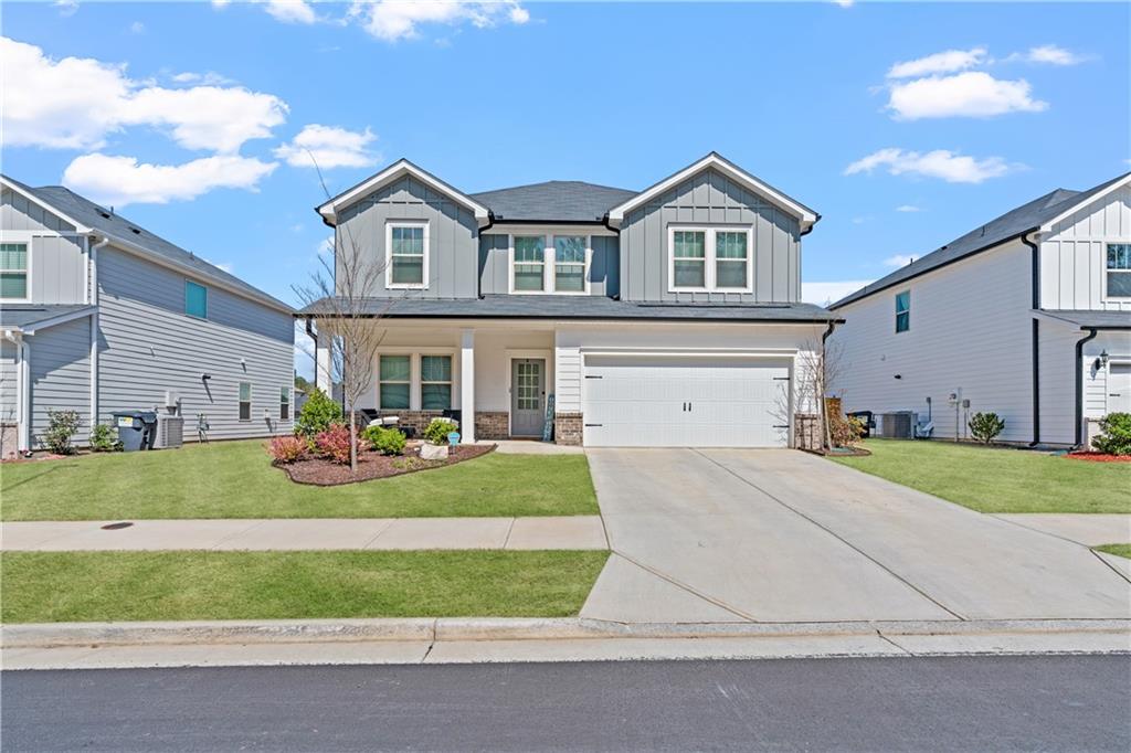 a front view of a house with a yard and garage