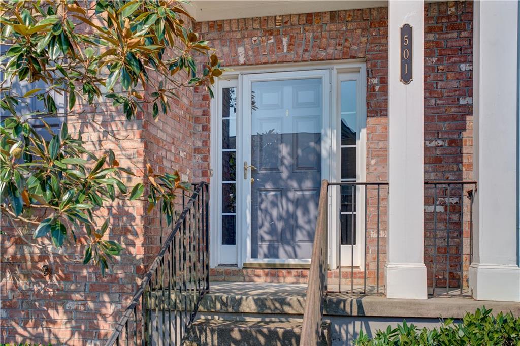 a view of a brick house with a tree