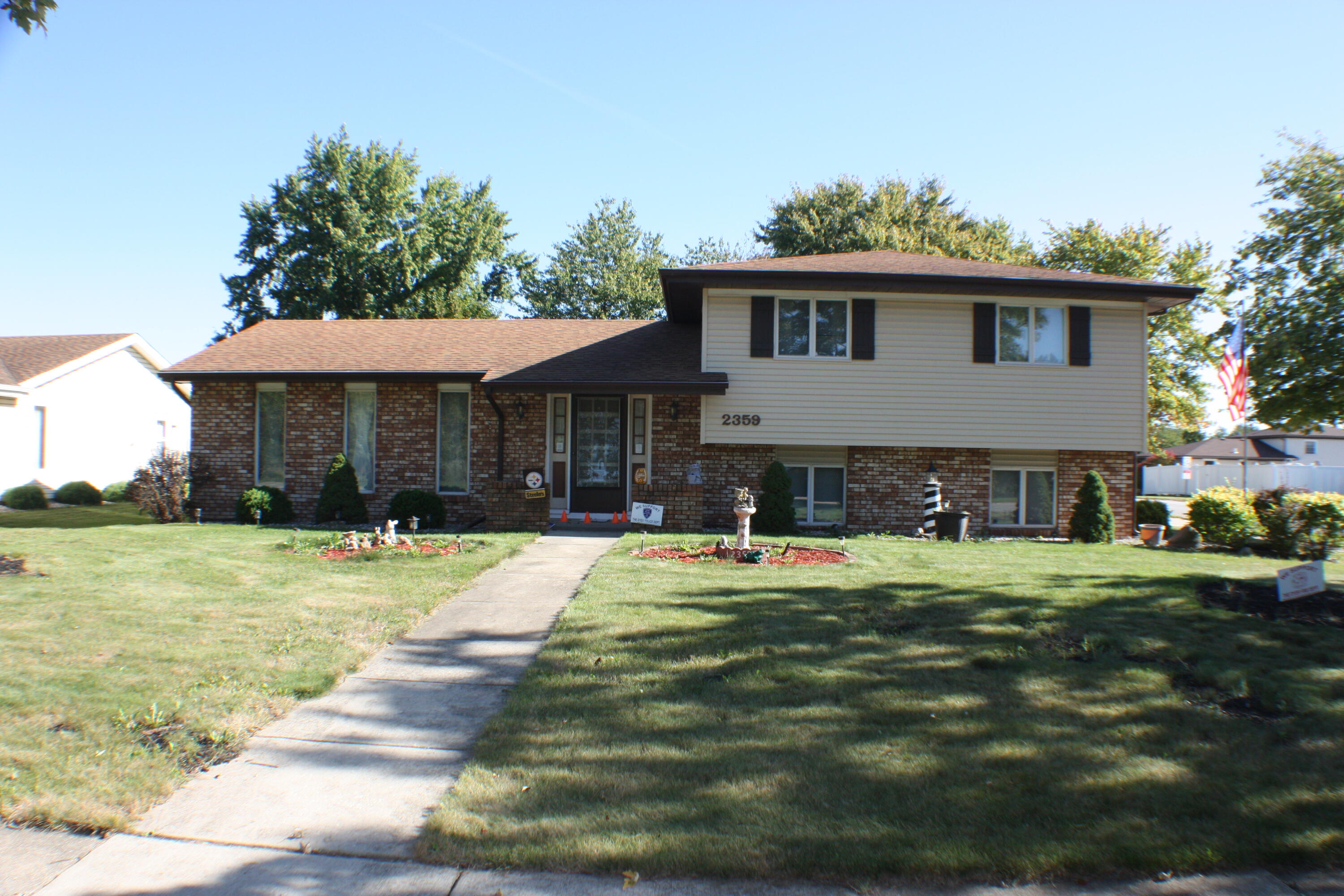 a front view of a house with a yard and porch