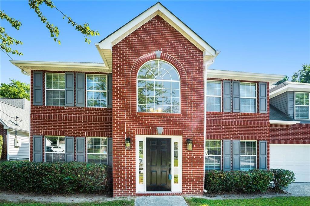 front view of brick house with a yard