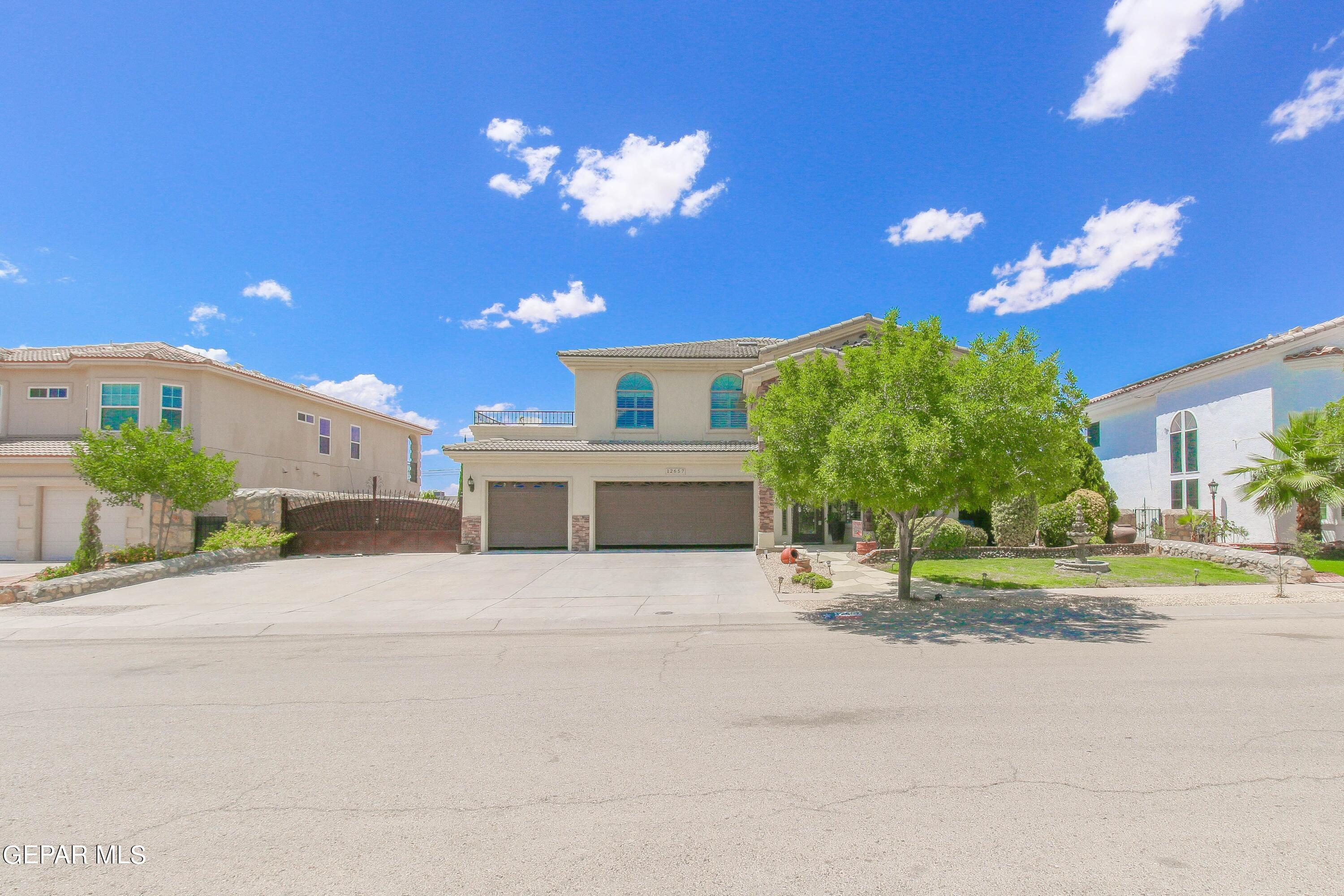 a front view of a house with a yard and a garage