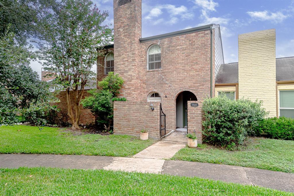 a front view of a house with a garden and plants