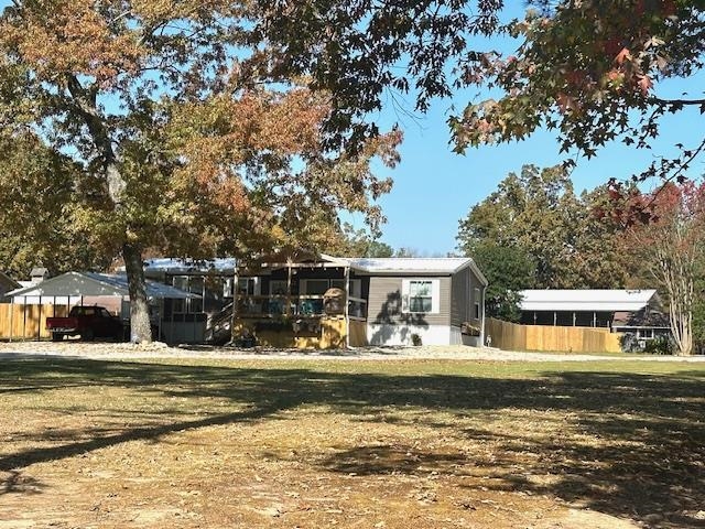 a front view of a house with a large trees