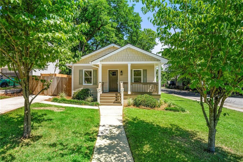 a front view of a house with yard and green space