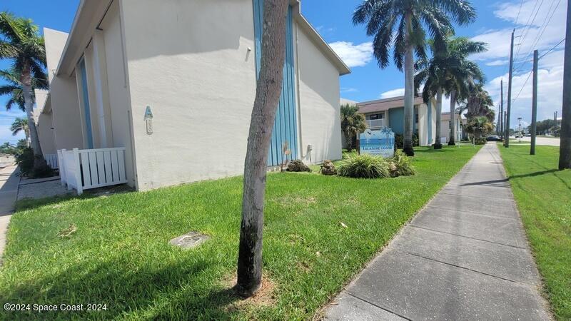 a view of a house with a yard and pathway