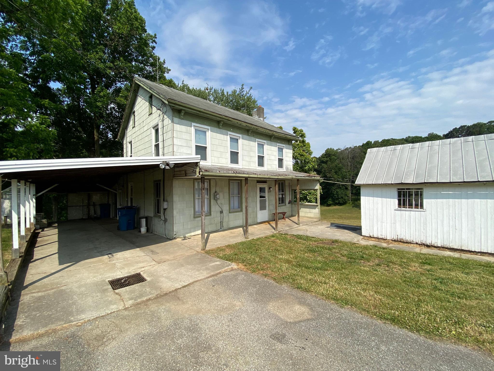 a backyard of a house with yard and garage