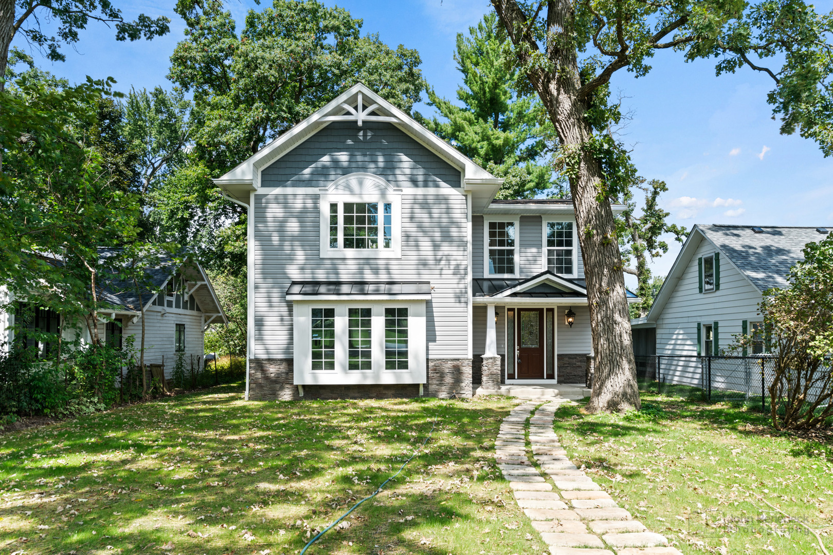 a front view of a house with a garden