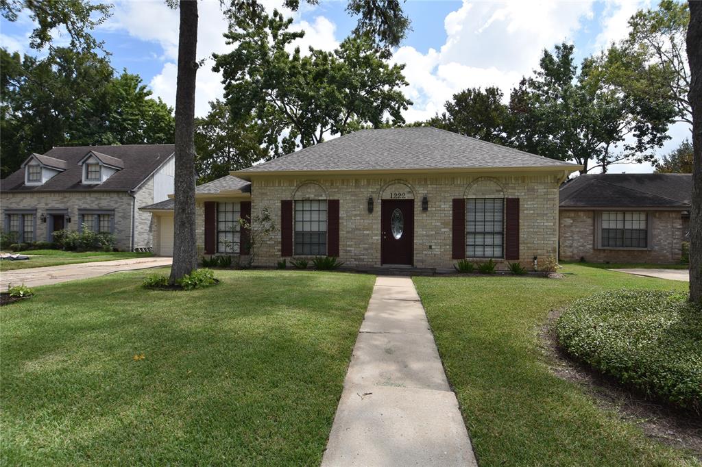 a front view of a house with a yard and porch