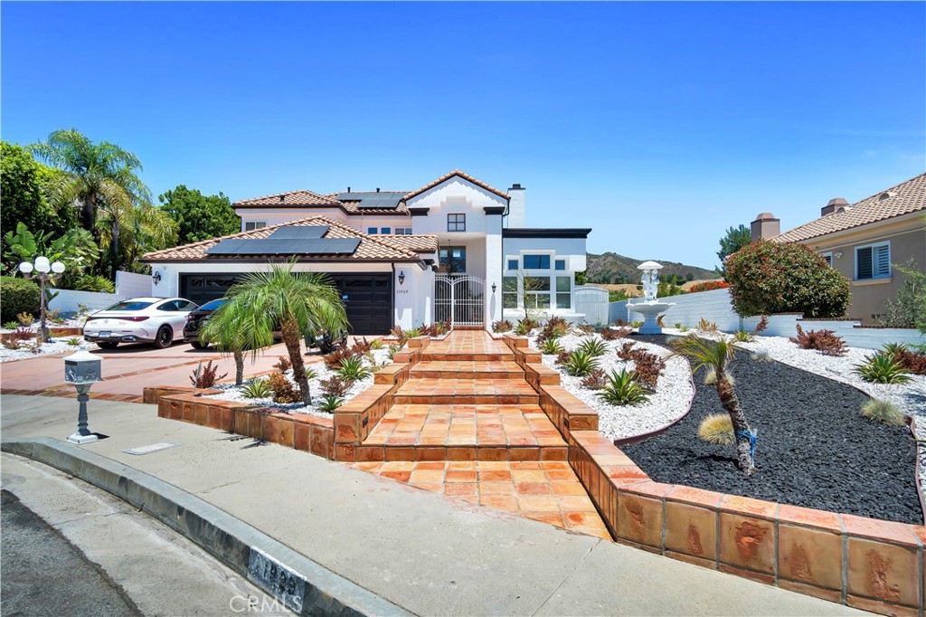 a view of a house with backyard and sitting area