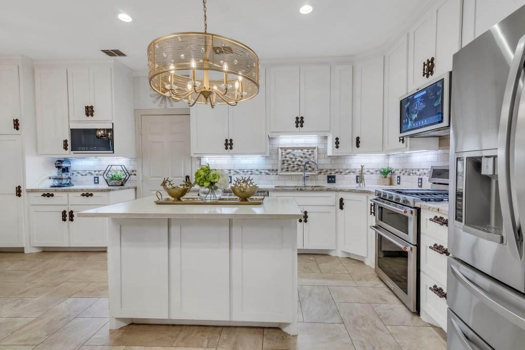 a kitchen with a sink stainless steel appliances and cabinets