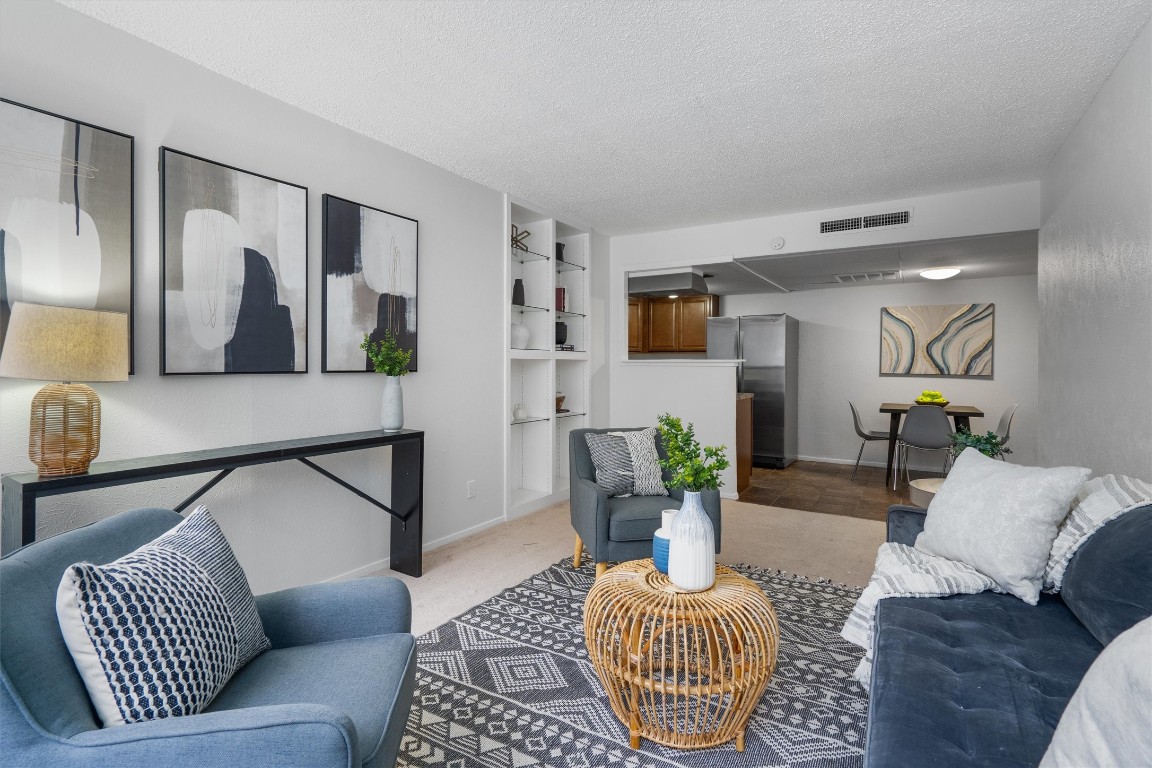 a living room with furniture and a rug