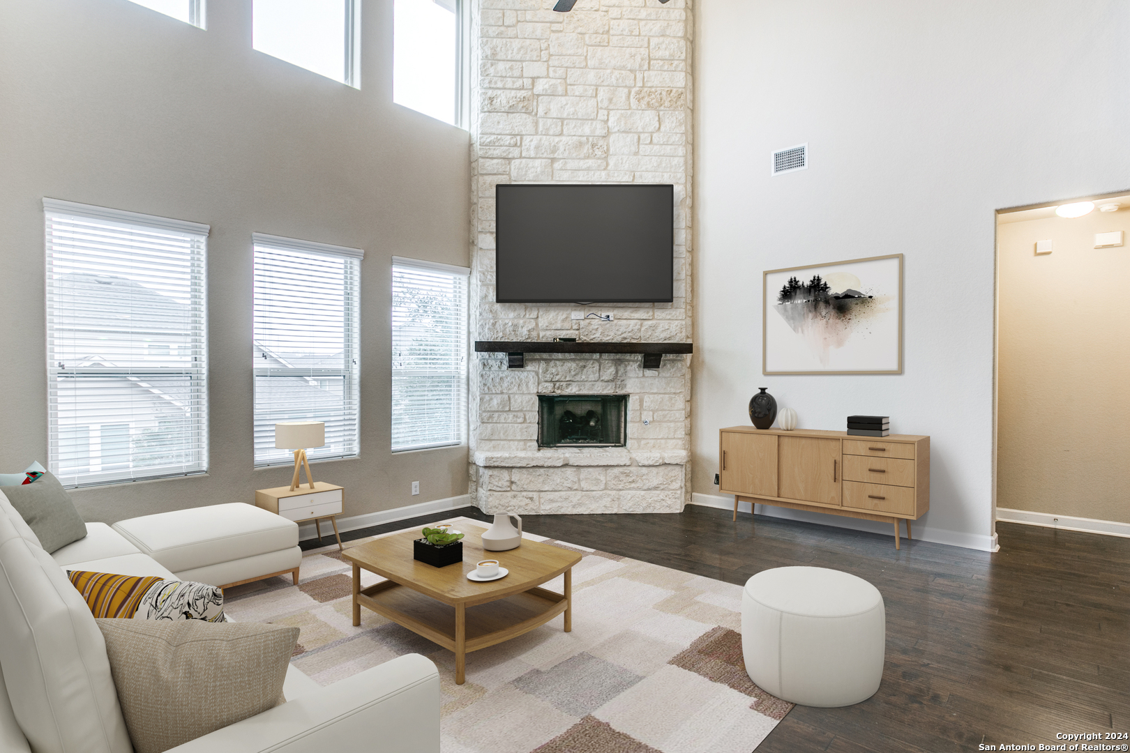 a living room with furniture a flat screen tv and a fireplace