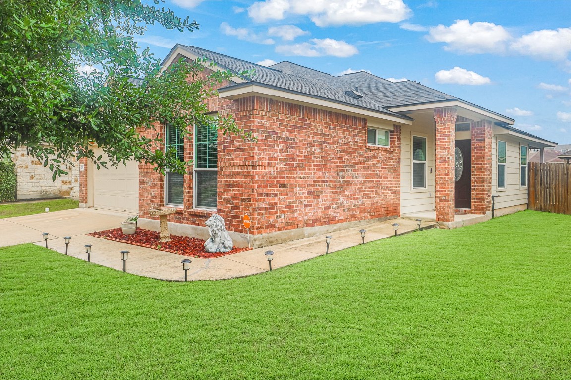 a front view of a house with a garden